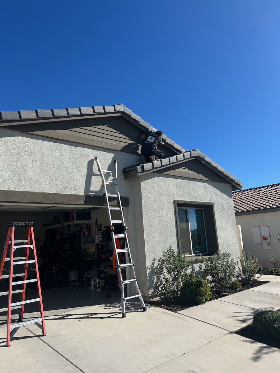 Our crew installing lighting on a roofline during the day