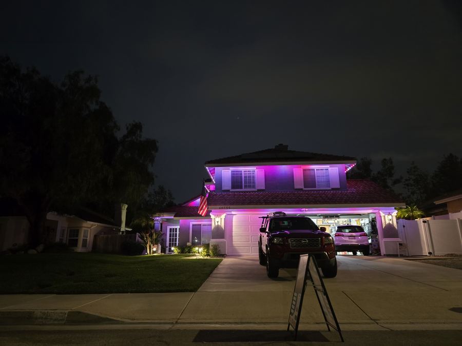 Home with pink and purple permanent LED roofline lighting